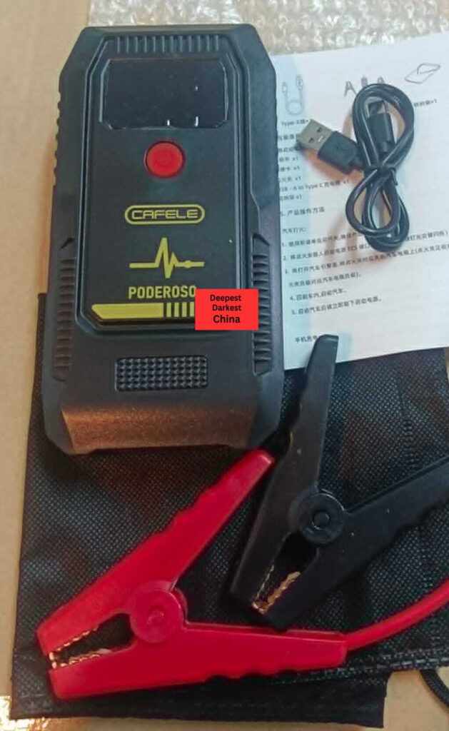 T-704 Jump Starter and accessories laid out on table.